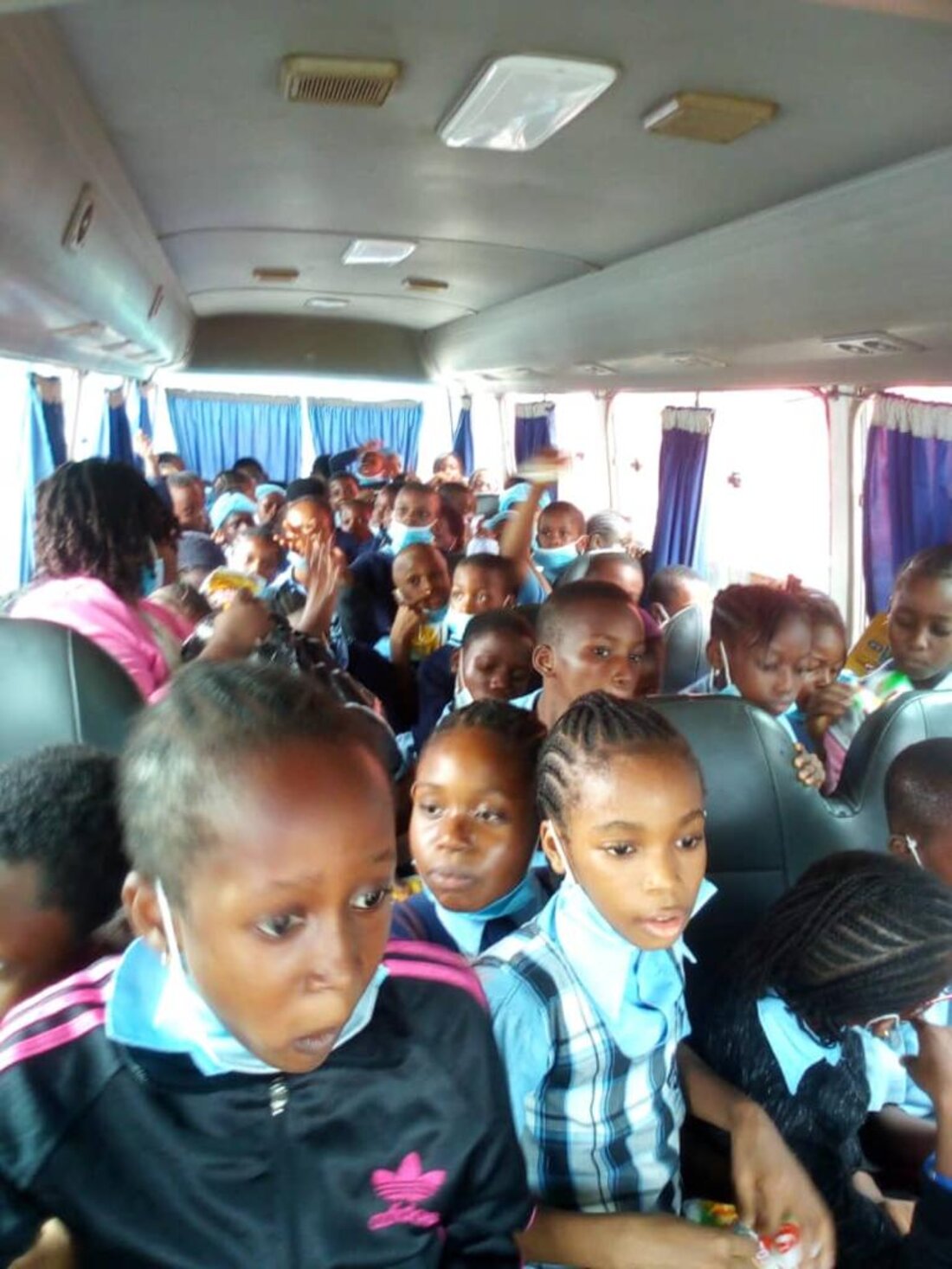 Young Adetola pupils together on a school excursion bus