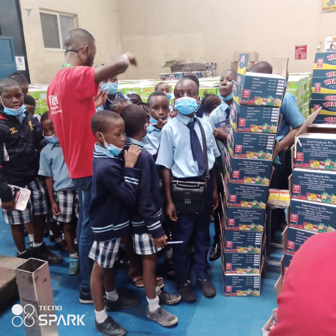 Adetola students on a guided tour of a juice production facility