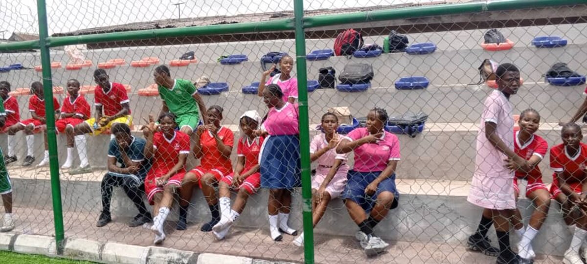 Adetola students seated by the pitch during a sports event
